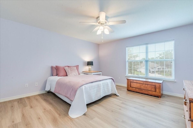 bedroom with light wood-type flooring and ceiling fan