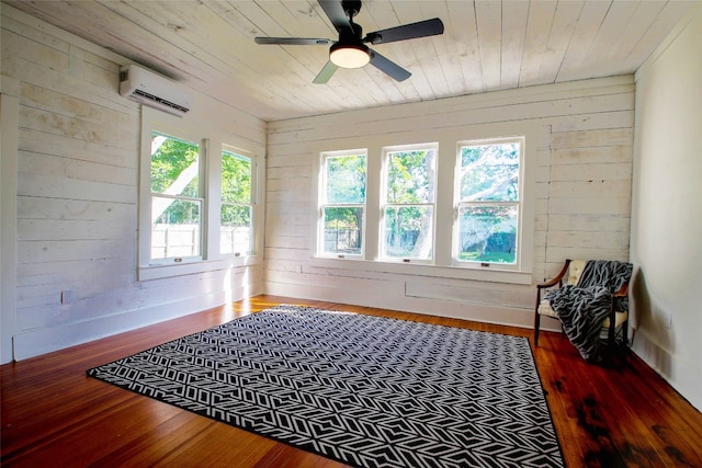 sunroom featuring a wall unit AC, wooden ceiling, and ceiling fan