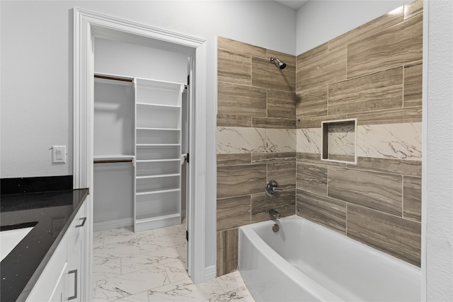 bathroom featuring vanity and tiled shower / bath combo