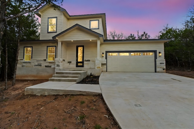 view of front of home with a garage and covered porch