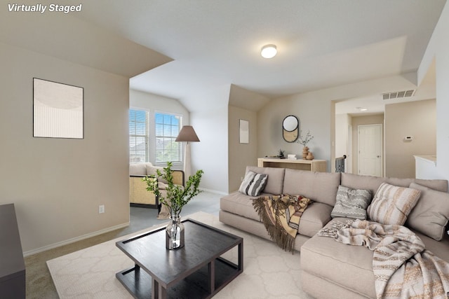 carpeted living room with lofted ceiling