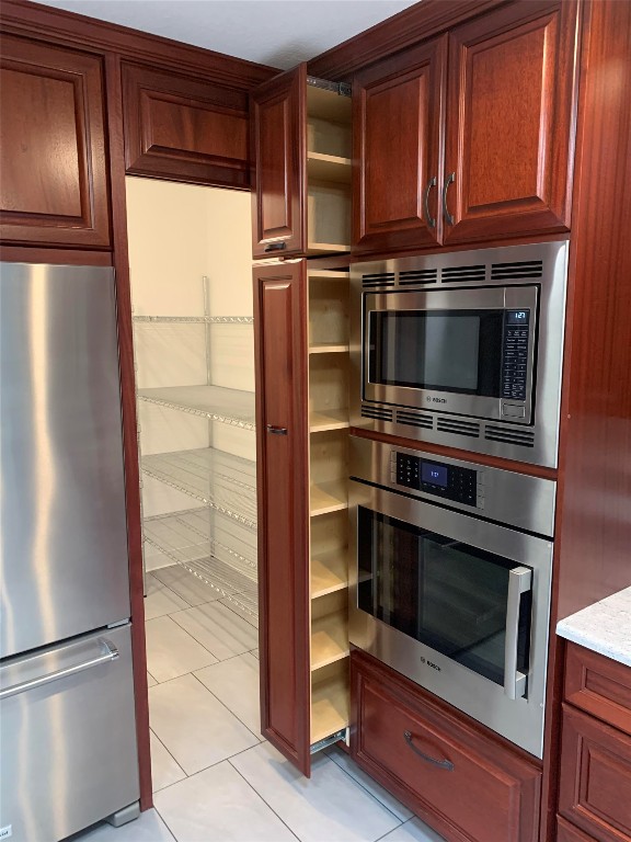 kitchen featuring appliances with stainless steel finishes and light tile patterned floors