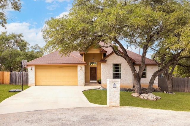 view of front of home featuring a front yard and a garage