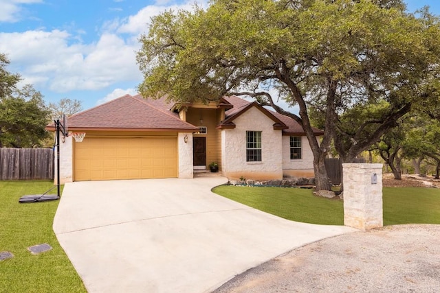 view of front of property with a garage and a front yard