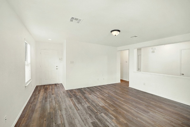 unfurnished room featuring dark hardwood / wood-style flooring