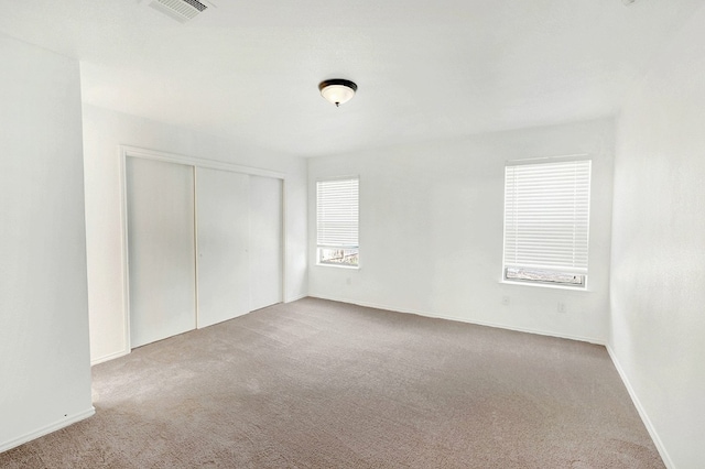 unfurnished bedroom with carpet and a closet