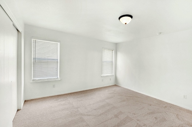 carpeted spare room featuring a wealth of natural light