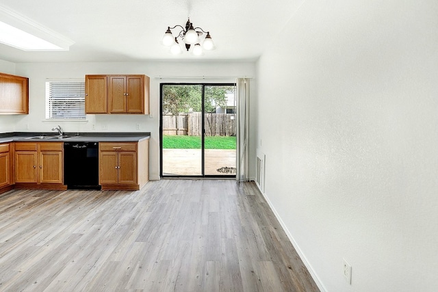 kitchen with sink, light wood-type flooring, a notable chandelier, and dishwasher