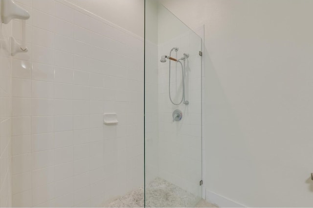 bathroom featuring a shower with door