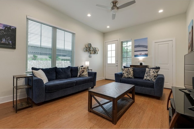 living room with light hardwood / wood-style floors and ceiling fan