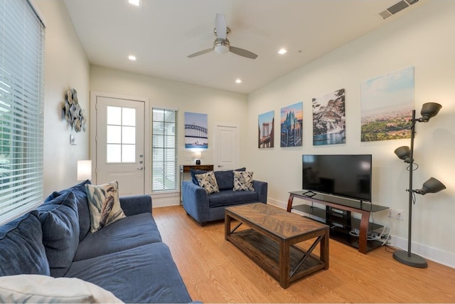 living room with ceiling fan and light wood-type flooring