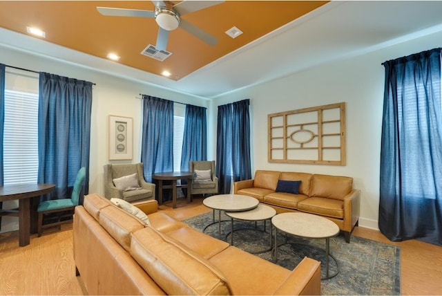 living room featuring ceiling fan and light wood-type flooring