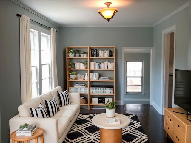 sitting room featuring ornamental molding and dark wood-type flooring