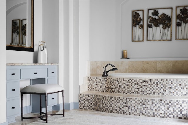 bathroom featuring tiled bath