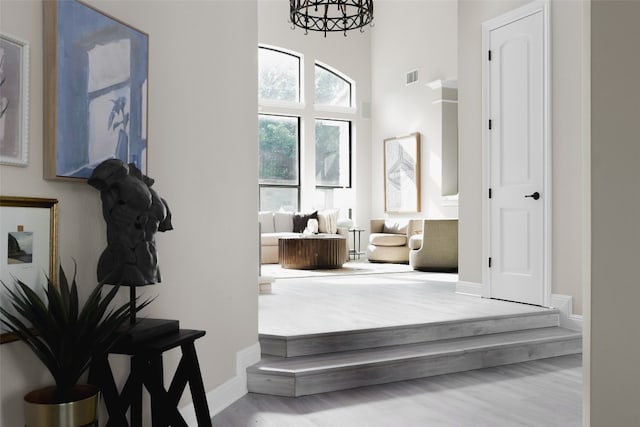 bathroom with wood-type flooring and a chandelier