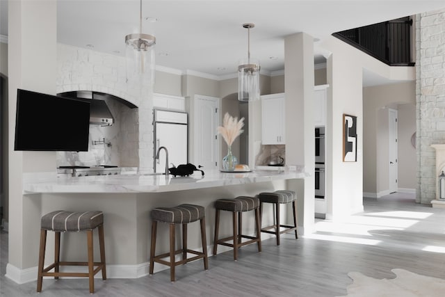 kitchen with white cabinets, decorative backsplash, white refrigerator, and light wood-type flooring