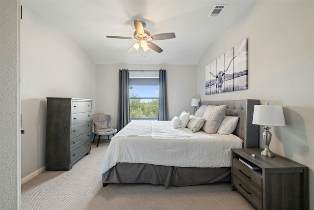 carpeted bedroom with ceiling fan and vaulted ceiling