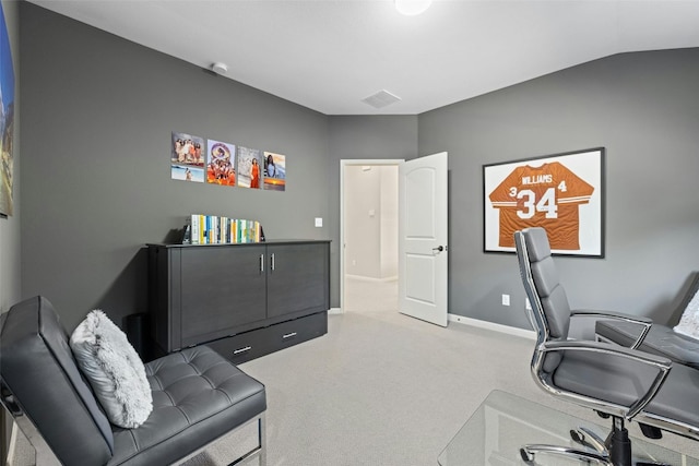 home office with light carpet and vaulted ceiling