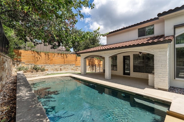 view of pool featuring ceiling fan and a patio area