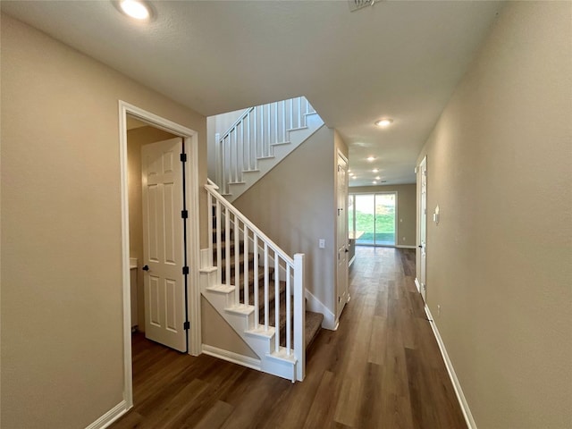 stairs featuring hardwood / wood-style flooring