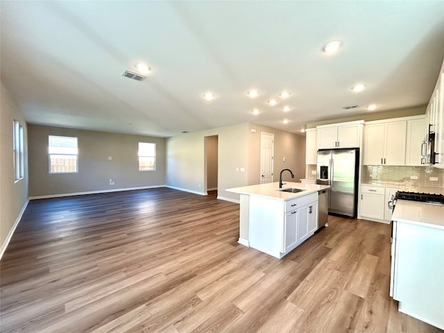 kitchen featuring light hardwood / wood-style floors, stainless steel appliances, and white cabinets