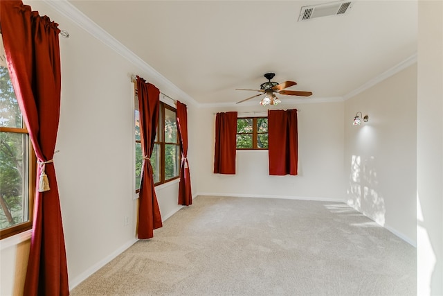 spare room with carpet flooring, ceiling fan, and crown molding