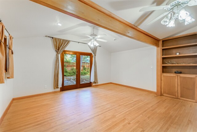 unfurnished living room with light wood-type flooring, french doors, and lofted ceiling with beams