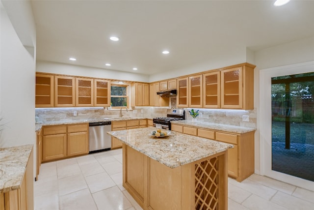 kitchen featuring light tile patterned floors, appliances with stainless steel finishes, decorative backsplash, and a kitchen island