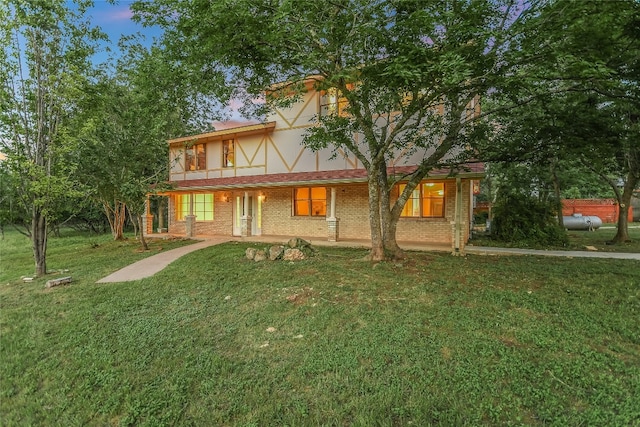 english style home with a lawn