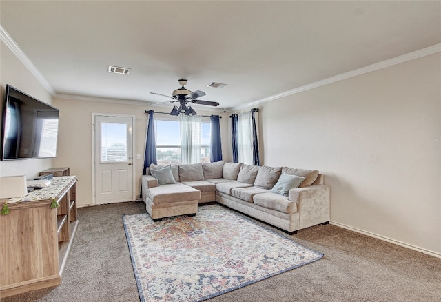 carpeted living room featuring crown molding and ceiling fan