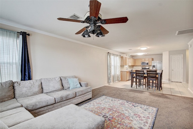 living room with light carpet, ceiling fan, and ornamental molding