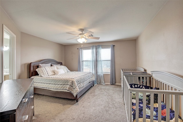 bedroom featuring light colored carpet and ceiling fan