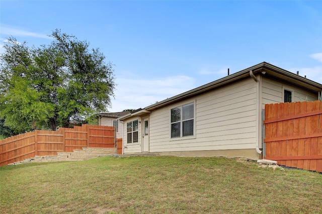 rear view of property featuring a yard