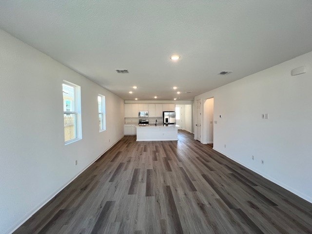 unfurnished living room featuring hardwood / wood-style flooring