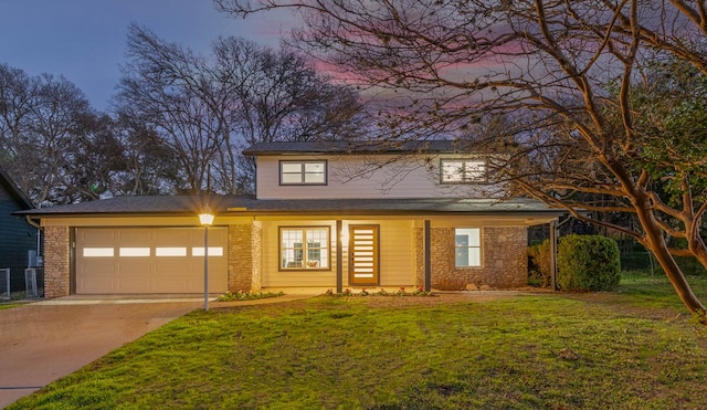 view of front of property with a garage and a lawn