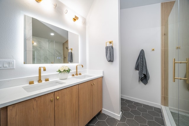 bathroom with a shower with shower door, tile patterned floors, and dual bowl vanity