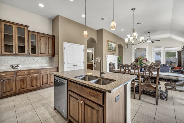 kitchen with decorative light fixtures, backsplash, ceiling fan with notable chandelier, lofted ceiling, and stainless steel dishwasher