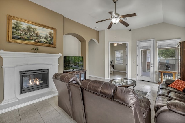 living room with ceiling fan, light tile floors, and lofted ceiling