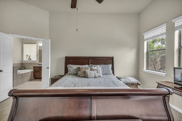 carpeted bedroom with connected bathroom and ceiling fan