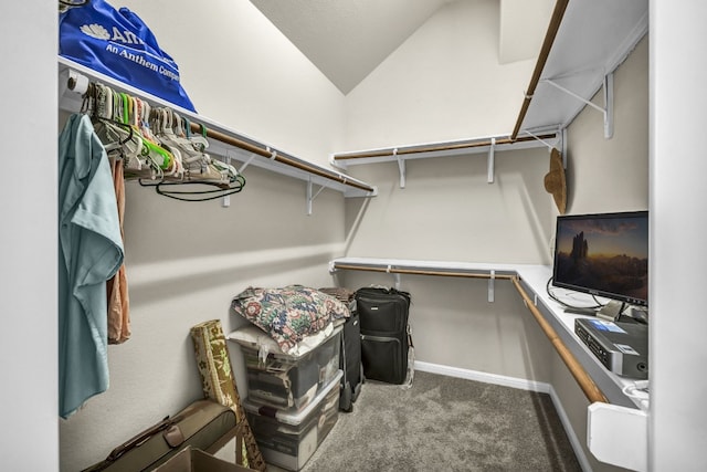 walk in closet with vaulted ceiling and carpet floors