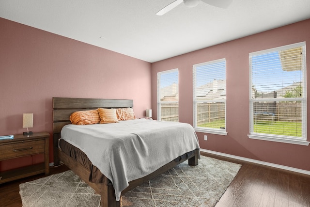 bedroom featuring ceiling fan and dark wood-type flooring