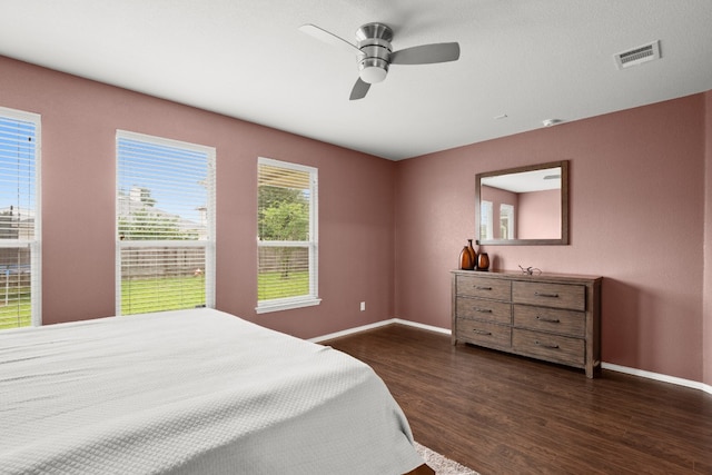 bedroom with ceiling fan and dark hardwood / wood-style floors