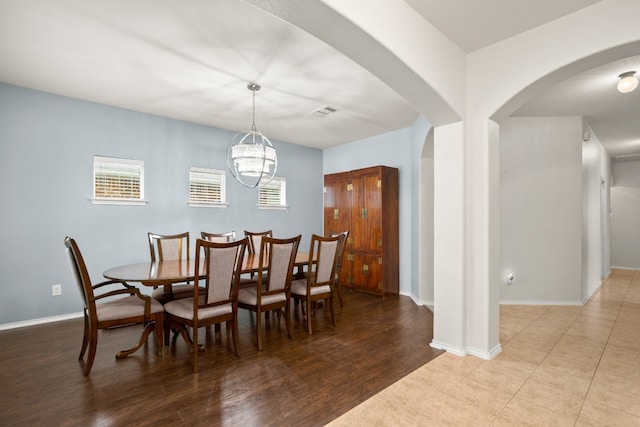 dining area featuring tile floors and a chandelier