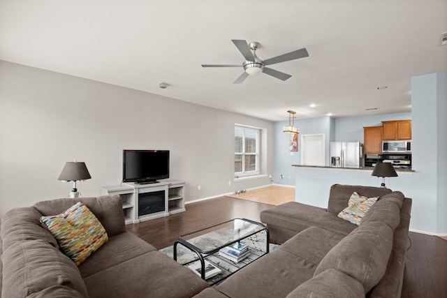 living room featuring ceiling fan and hardwood / wood-style floors