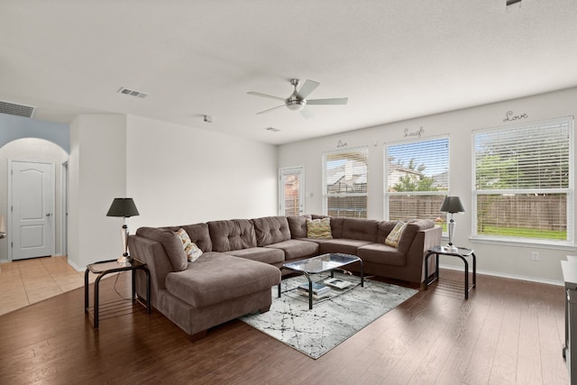 living room featuring wood-type flooring and ceiling fan