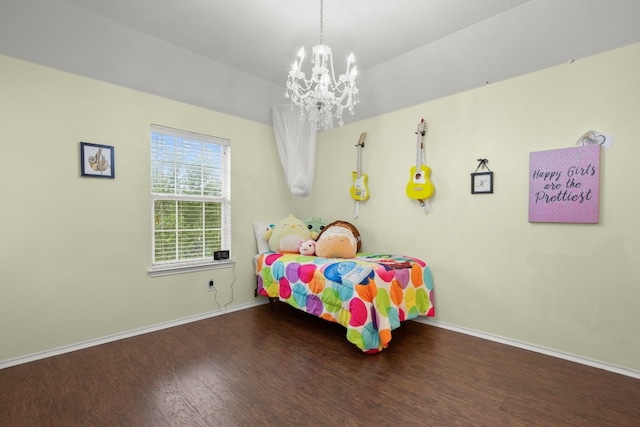 bedroom with hardwood / wood-style flooring and a chandelier