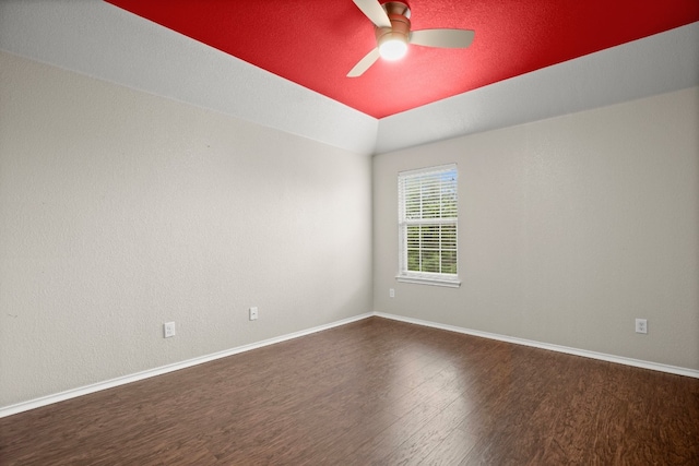 empty room featuring ceiling fan and dark wood-type flooring