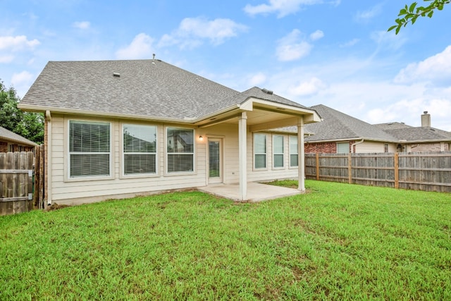 back of property with a patio area and a lawn