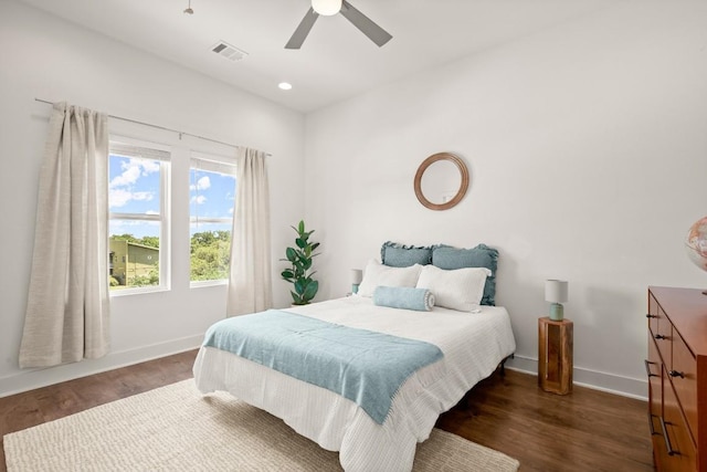 bedroom with ceiling fan and dark hardwood / wood-style flooring