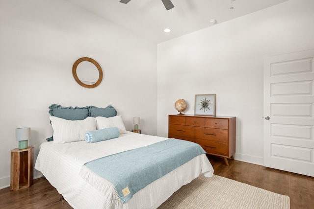 bedroom with dark hardwood / wood-style flooring and ceiling fan